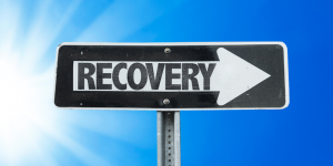 a sign pointing to recovery