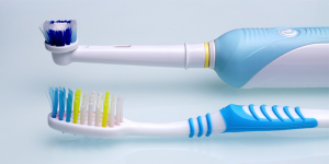 a manual and electric toothbrush side by side